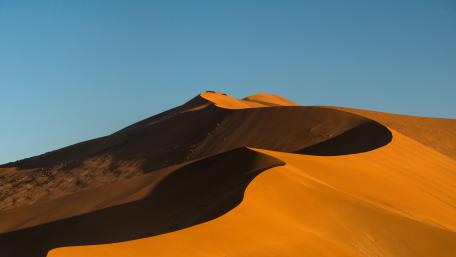Desert Dunes Under Clear Blue Sky wallpaper