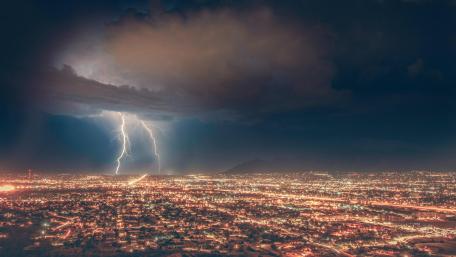 Thunderstorm Over Cityscape at Night wallpaper