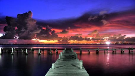Vibrant Sunset Over a Tranquil Pier wallpaper