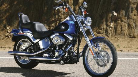 Classic Chrome Motorcycle on Scenic Roadway wallpaper