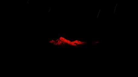Fiery Mountain Crest Under Starry Night wallpaper