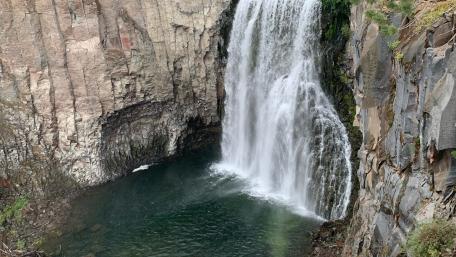 Majestic Waterfall Cascading Into Serene Pool wallpaper
