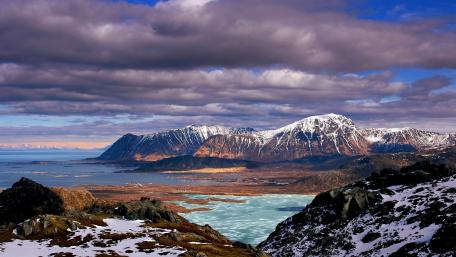 Majestic Mountains and Dark Clouds Over Sea wallpaper