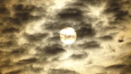 Cumulus Clouds Embracing a Golden Sun wallpaper