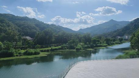 Serene River Flowing Through Majestic Mountains in 4K wallpaper