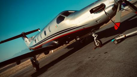 Sleek Private Aircraft on Tarmac Scene with Blue Sky Background wallpaper