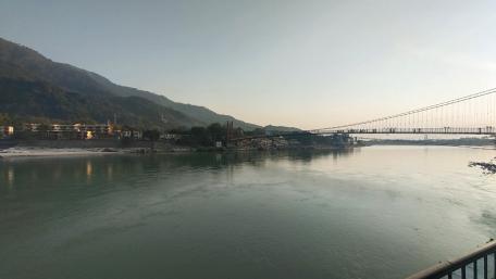 Tranquil River View with Mountains and Bridge Overhead wallpaper
