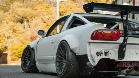 Sleek Sports Car Sunlit Street Pose wallpaper