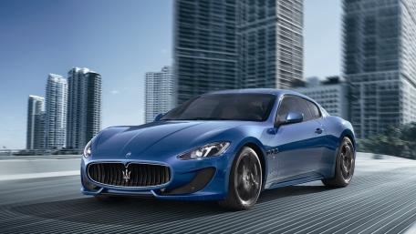 Sleek Maserati GranTurismo on a Vibrant City Road wallpaper