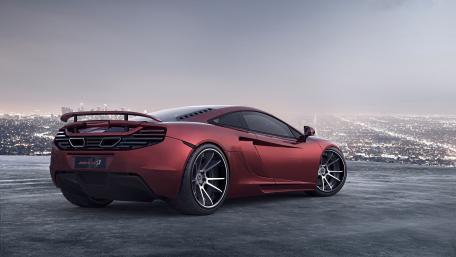 Sleek McLaren Supercar Against a City Skyline wallpaper