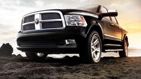Sleek Dodge Ram Pickup at Sunset Beach Scene wallpaper