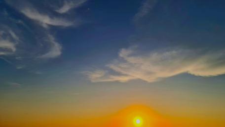 Golden Sunrise Over Serene Skies wallpaper