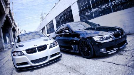 Sleek BMW M3 Duo in Urban Setting wallpaper