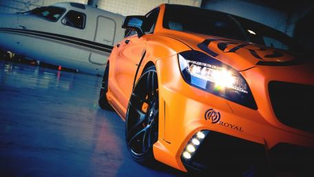 Bold Orange Mercedes-Benz Under Hangar Lights wallpaper