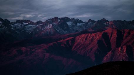 Majestic Mountain Range Under Cloudy Skies wallpaper