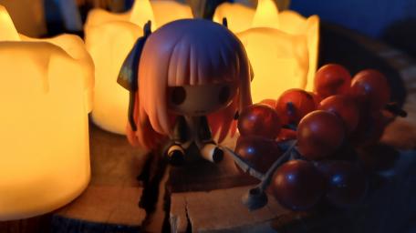 Charming Anime Toy Among Warm Candlelight wallpaper