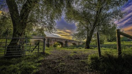 Serene Bridge in a Rural Landscape wallpaper