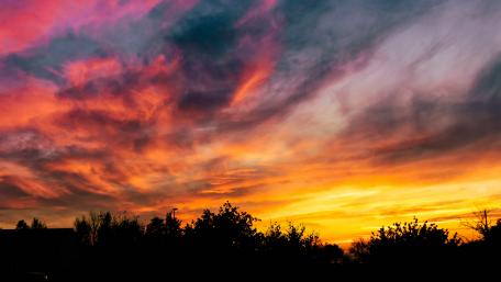 Vibrant Sunset Over a Tranquil Landscape wallpaper