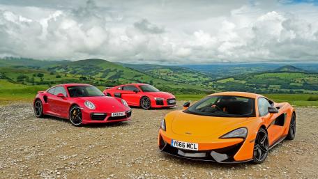 Exotic Cars in Scenic Landscape wallpaper