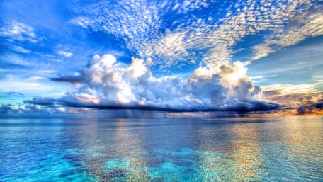 Serene Blue Sea Under Rain Clouds wallpaper