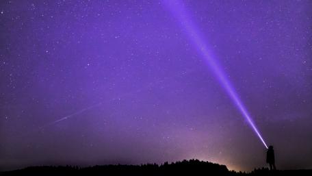 Majestic Starry Night with Flashlight Beam wallpaper