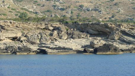 Beautiful Rocky Shoreline Under Clear Blue Sky wallpaper