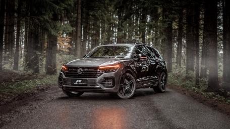 Sleek Volkswagen Touareg Hybrid in a Serene Forest Setting wallpaper