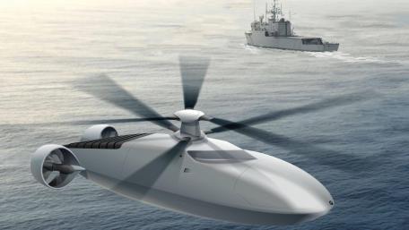 Advanced Military Helicopter in Action Above the Ocean Surface wallpaper
