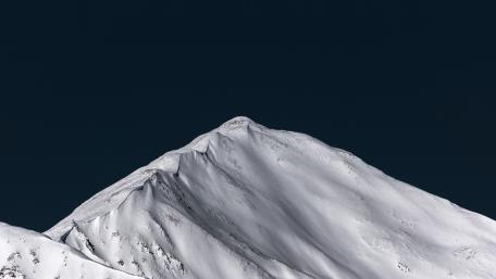 Majestic Snow-Capped Mountain Under Night Sky wallpaper
