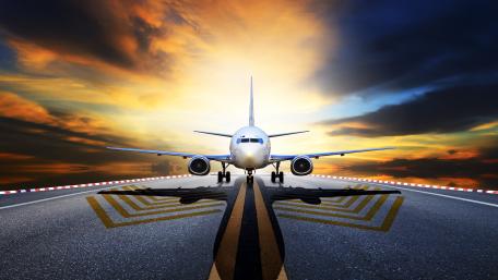 Majestic Airplane on Runway under Dramatic Sky wallpaper
