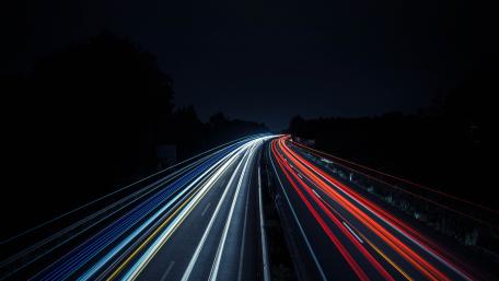 Highway Light Trails Under the Night Sky 5K wallpaper