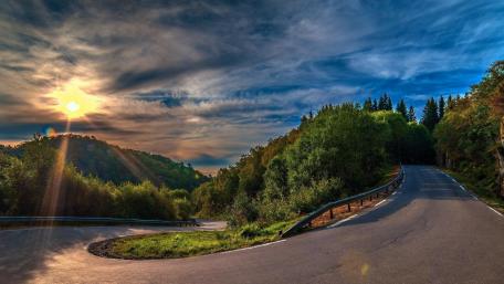 Curvy Road Under Sunlit Skies wallpaper