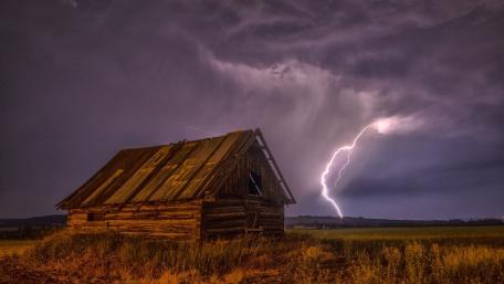 Stormy Night Over a Rustic Cottage wallpaper