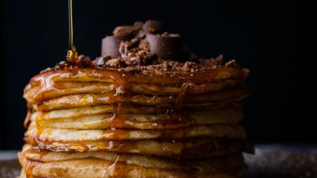 Delicious Stack of Pancakes with Maple Syrup Drizzle wallpaper