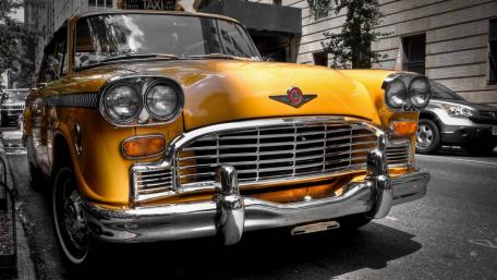 Classic Yellow Vintage Car in Urban Setting wallpaper