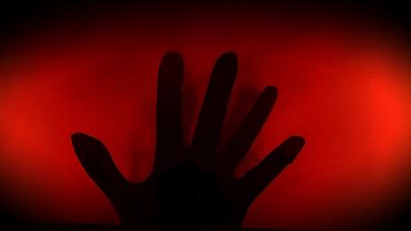 Abstract Hand Silhouette Against Fiery Background wallpaper