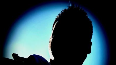 Mysterious Silhouette Against Vibrant Background wallpaper