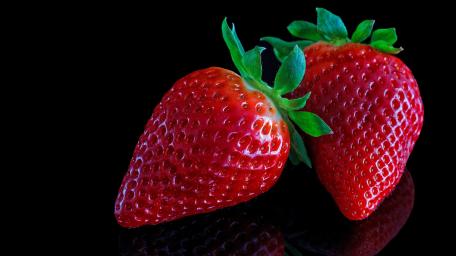 Vibrant Strawberries on Black Background wallpaper