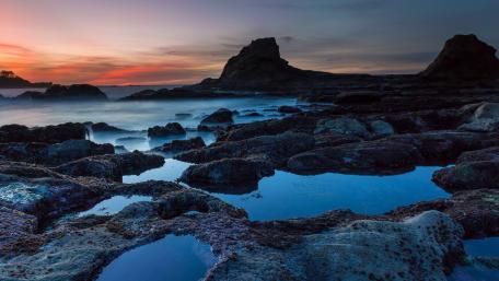 Mystical Rocky Shore at Sunset wallpaper