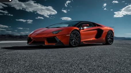 Red Lamborghini Against Dramatic Sky wallpaper