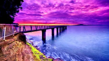 Vibrant Purple Sky Over Serene Pier Waters wallpaper