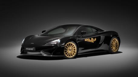 Sleek Black McLaren 570GT with Gold Accents wallpaper
