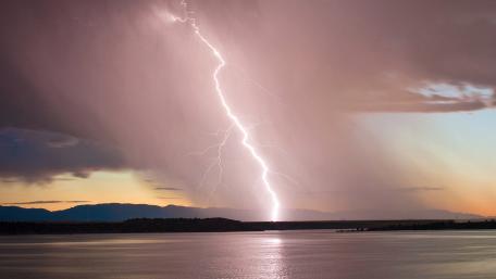 Majestic Lightning Over Serene Lake wallpaper