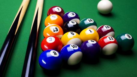 Classic Pool Balls Ready for Action on Green Felt Surface wallpaper