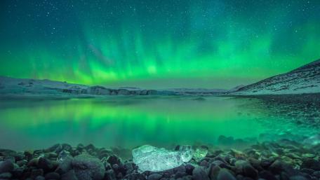 Aurora Reflections Over Icy Lake at Night wallpaper