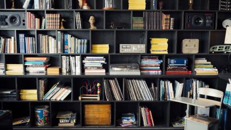 Cozy Library Shelf with a Collection of Books and Decor wallpaper