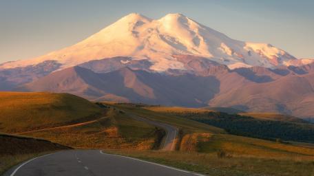 Majestic Mountain Road View in Nature's Embrace wallpaper