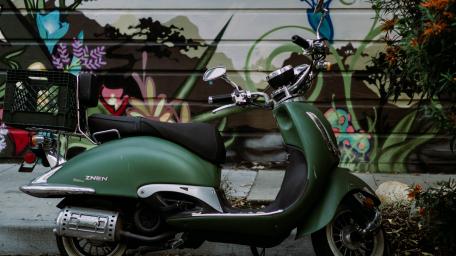 Vintage Vespa Scooter Against Colorful Mural Background wallpaper