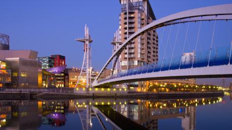 Serene Cityscape at Dusk with Illuminated Bridge and Reflections wallpaper