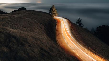 Serene Road Through a Sea of Clouds at Dawn wallpaper